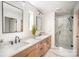 Spa-like bathroom boasts double vanities, modern fixtures, and a glass-enclosed shower at 4547 Kings Ct, Hickory, NC 28602