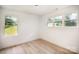 Light-filled bedroom features wood floors and multiple windows offering a pleasant view at 4547 Kings Ct, Hickory, NC 28602