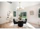 Bright dining room features a modern light fixture, round glass table and black velvet chairs at 4547 Kings Ct, Hickory, NC 28602