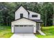 Charming two-story modern farmhouse with vertical siding, black trim, and a gray garage door at 4547 Kings Ct, Hickory, NC 28602