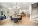 Open-concept living area with dining table and chairs, bright windows and hardwood floors at 4547 Kings Ct, Hickory, NC 28602