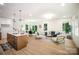 Open-concept living area with dining table and chairs, bright windows and hardwood floors at 4547 Kings Ct, Hickory, NC 28602
