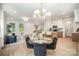 Open-concept living area with dining table and chairs, bright windows and hardwood floors at 4547 Kings Ct, Hickory, NC 28602