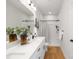 Modern bathroom with double vanity, sleek fixtures, and a shower with curtain at 4815 & 4817 Victoria Dr, Charlotte, NC 28269