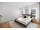 Inviting bedroom with large windows, neutral decor, and wood-look flooring at 4815 & 4817 Victoria Dr, Charlotte, NC 28269