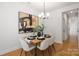 Bright dining room featuring stylish chandelier, modern art and wood-look floors at 4815 & 4817 Victoria Dr, Charlotte, NC 28269