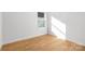 Bright, empty room with wood-look flooring and a window at 4815 & 4817 Victoria Dr, Charlotte, NC 28269