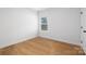 Empty room with a window, door and wood-look flooring at 4815 & 4817 Victoria Dr, Charlotte, NC 28269