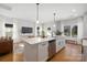 Open kitchen with stainless steel appliances, a large center island, and a view into the living area at 4815 & 4817 Victoria Dr, Charlotte, NC 28269