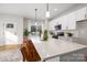 Bright kitchen featuring a large island, stainless steel appliances, and modern white cabinets with black hardware at 4815 & 4817 Victoria Dr, Charlotte, NC 28269