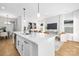 Open kitchen with a large island, stainless steel appliances, and view to the dining and living area at 4815 & 4817 Victoria Dr, Charlotte, NC 28269