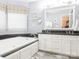 Relaxing bathroom with a soaking tub, double vanity, and updated fixtures at 5417 Bedfordshire Ave, Harrisburg, NC 28075