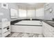Relaxing bathroom featuring a soaking tub, granite countertops, and bright natural lighting at 5417 Bedfordshire Ave, Harrisburg, NC 28075