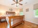 Cozy bedroom with a wood bed, hardwood floors, natural light, and a ceiling fan at 5417 Bedfordshire Ave, Harrisburg, NC 28075