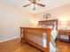 This bedroom features a wooden bed frame, hardwood floors, neutral color scheme, and great natural lighting at 5417 Bedfordshire Ave, Harrisburg, NC 28075