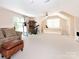 Spacious bonus room with a ceiling fan, carpet flooring, and versatile space at 5417 Bedfordshire Ave, Harrisburg, NC 28075