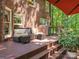 Outdoor deck features wicker furniture, grill, and steps down to yard at 5417 Bedfordshire Ave, Harrisburg, NC 28075