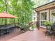 View of the outdoor deck space featuring a dining table and outdoor patio furniture at 5417 Bedfordshire Ave, Harrisburg, NC 28075
