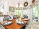 Dining room with hardwood floors, built-in bench seating and floral valances at 5417 Bedfordshire Ave, Harrisburg, NC 28075