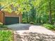 Driveway leading to a two car garage and backyard with mature trees at 5417 Bedfordshire Ave, Harrisburg, NC 28075