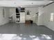 Clean garage with shelving, storage, and epoxy flooring at 5417 Bedfordshire Ave, Harrisburg, NC 28075