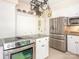 White kitchen featuring granite countertops, stainless steel appliances, and ample cabinet space at 5417 Bedfordshire Ave, Harrisburg, NC 28075