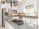 Bright kitchen with granite countertops, stainless steel appliances, and a pot rack at 5417 Bedfordshire Ave, Harrisburg, NC 28075