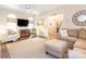 Bright living room with hardwood floors, plush furniture, and arched windows at 5417 Bedfordshire Ave, Harrisburg, NC 28075