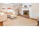 Cozy living room featuring a fireplace, plush seating, and hardwood floors at 5417 Bedfordshire Ave, Harrisburg, NC 28075