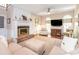 Inviting living room with a cozy fireplace, plush seating, and abundant natural light from large windows at 5417 Bedfordshire Ave, Harrisburg, NC 28075