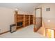 Spacious loft area featuring carpeted floors, a built-in bookcase, and access to additional rooms at 5417 Bedfordshire Ave, Harrisburg, NC 28075