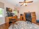 Well-lit home office featuring hardwood floors, a desk, and a ceiling fan at 5417 Bedfordshire Ave, Harrisburg, NC 28075