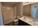 Bathroom featuring double vanity, toilet, and shower with tub at 5823 Natick Dr, Charlotte, NC 28214