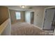 Neutral bedroom featuring wall to wall carpeting and a bright window for natural light at 5823 Natick Dr, Charlotte, NC 28214