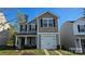 Charming two-story home featuring a one-car garage and landscaped front yard at 5823 Natick Dr, Charlotte, NC 28214