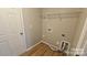 Functional laundry room with convenient shelving and modern connections at 5823 Natick Dr, Charlotte, NC 28214