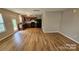 Open concept kitchen and living space featuring wood floors and stainless appliances at 5823 Natick Dr, Charlotte, NC 28214
