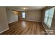 Open floor plan showcasing wood floors and natural light through large windows at 5823 Natick Dr, Charlotte, NC 28214