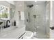 Modern bathroom featuring marble shower, sleek vanity with black fixtures, and window providing natural light at 5910 Grosner Pl, Charlotte, NC 28211