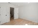Bright bedroom with hardwood floors featuring multiple closets for convenient and organized storage at 5910 Grosner Pl, Charlotte, NC 28211