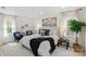 Well-lit bedroom featuring neutral decor, plush carpet, and coordinated furnishings for a serene retreat at 5910 Grosner Pl, Charlotte, NC 28211