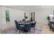 Bright dining area with modern furnishings and decor, and open view to front entryway at 5910 Grosner Pl, Charlotte, NC 28211