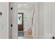 A bright entryway featuring hardwood floors, a decorative front door, and natural light at 5910 Grosner Pl, Charlotte, NC 28211