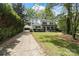 Beautiful two-story home with a well-manicured lawn, a detached garage, and a long driveway at 5910 Grosner Pl, Charlotte, NC 28211