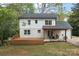 Beautiful white home with dark roof and deck, nestled in a lush, green yard at 5910 Grosner Pl, Charlotte, NC 28211