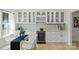 Bright kitchen features white cabinets, marble countertops, wine rack, and a built-in wine fridge at 5910 Grosner Pl, Charlotte, NC 28211