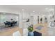 Open concept with white cabinets, marble countertops, stainless steel appliances, and dining area with a blue accent at 5910 Grosner Pl, Charlotte, NC 28211