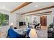 A full living room featuring hardwood floors, wooden beams, a modern fireplace, and stylish decor at 5910 Grosner Pl, Charlotte, NC 28211