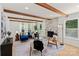 Bright living room featuring hardwood floors, wooden beams, a modern fireplace, and stylish decor at 5910 Grosner Pl, Charlotte, NC 28211