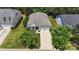 Aerial view of the home featuring a 2 car garage, a driveway, and a manicured front lawn at 611 Tee Ridge Ct, Fort Mill, SC 29715